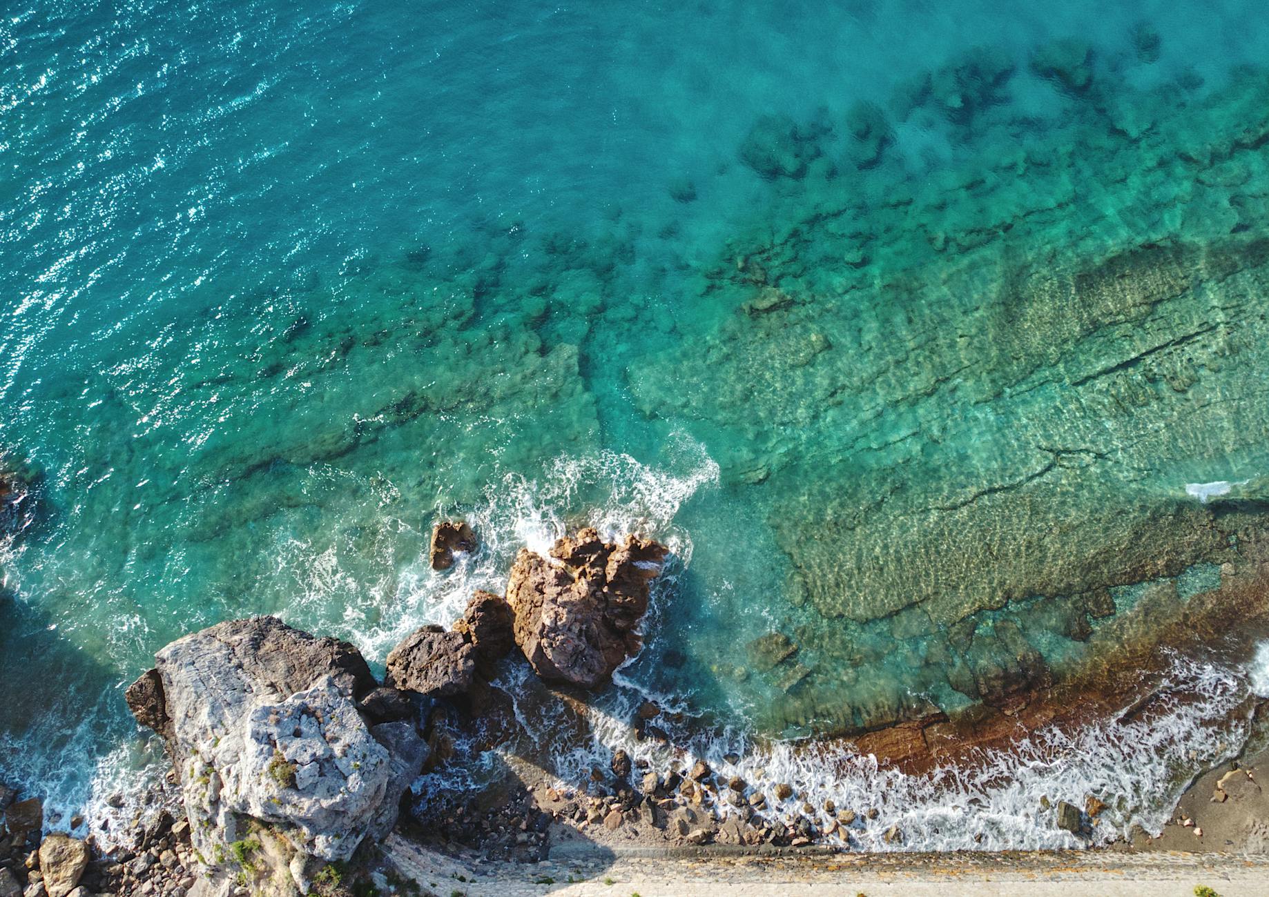Aerial drone view of a Mediterranean coastline at golden hour